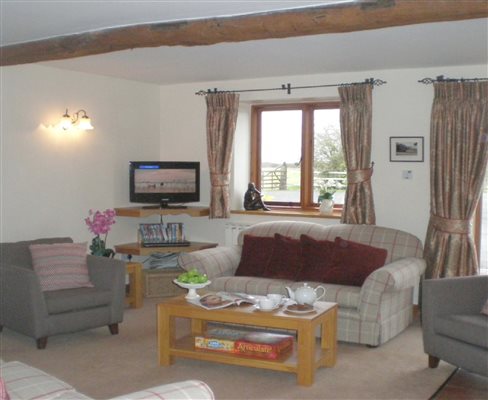 Ploughmans Rest sitting room, with views across the front field where the Ram sheep holiday with us.